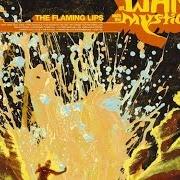 El texto musical THE WIZARD TURNS ON... THE GIANT SILVER FLASHLIGHT AND PUTS ON HIS WEREWOLF MOCCASINS de THE FLAMING LIPS también está presente en el álbum At war with the mystics (2006)